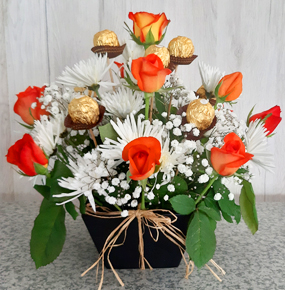 With orange roses, white chrysanthemum and Ferrero Chocolates 