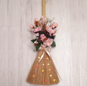 Hanging broom wall decoration